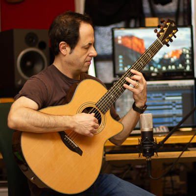 Jac in studio with acoustic guitar